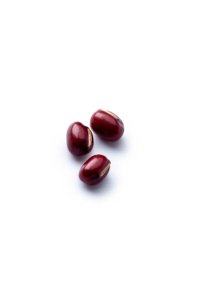 Three red kidney beans isolated on white background, studio shot.