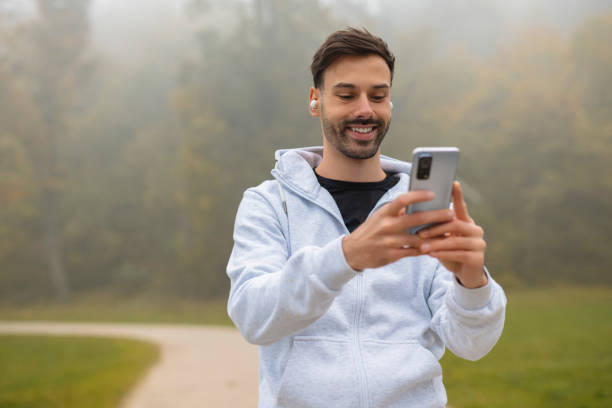 istock Portrait of man using phone to select music for jogging 2192825687