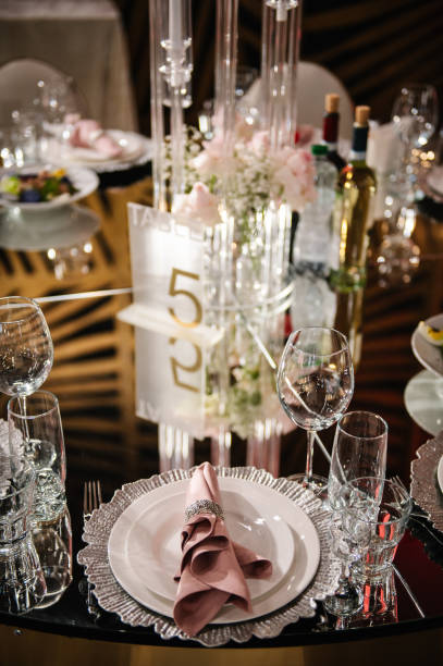 istock Serving, setting table. Plate decorated linen pink napkin and silverware cutlery, glasses. Wedding set up, dinner table reception. Birthday, baptism, event. Luxury silver decor. Side view. Closeup. 2192827245
