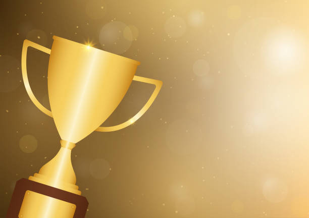 istock Golden Trophy Cup on Golden Shiny Background. Champion and Winning or Celebration Concept. 2192827736