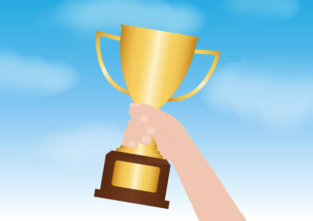 istock Hand Holding Golden Trophy Cup. Champion and Winning Concept. 2192827786