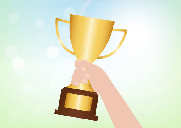 istock Hand Holding Golden Trophy Cup. Champion and Winning Concept. 2192827797