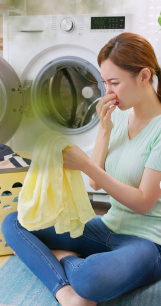 istock woman take clothes from washer 2192831385