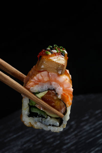 istock Sushi with chopsticks on the black 2192833490