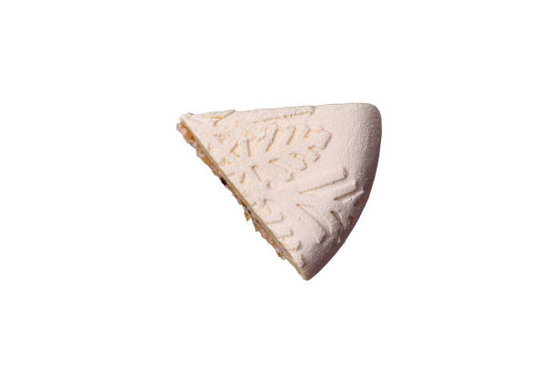 Piece of cheesecake with nuts and berries with winter pattern on white background