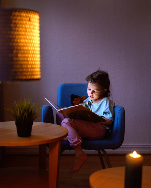 istock A little girl reading a book 2192835361