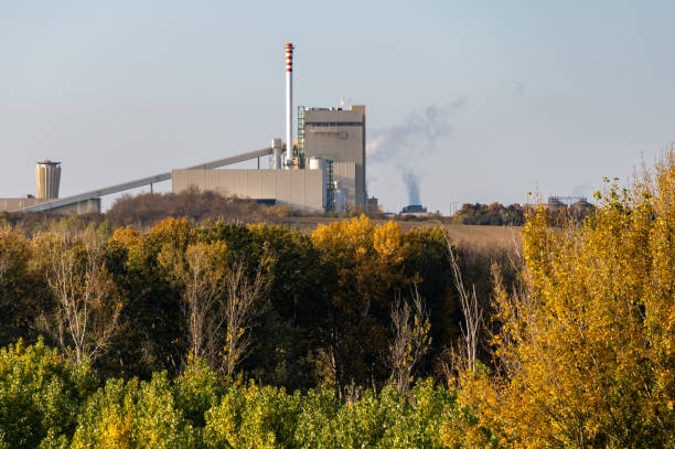 istock Industrial facility with chimney near an autumn forest 2192835977