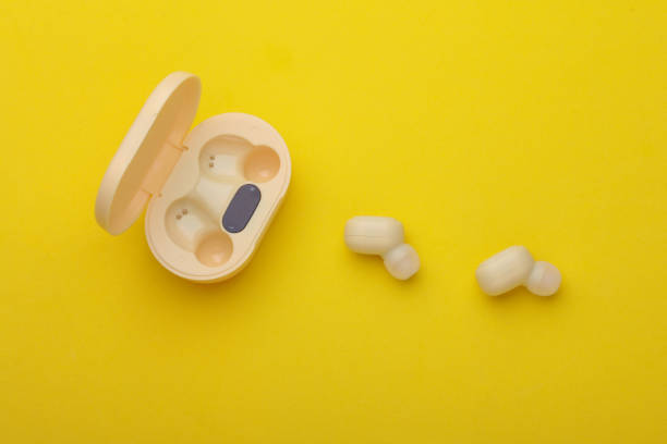 istock Wireless Earphones with Charging Case on yellow Background 2192836674