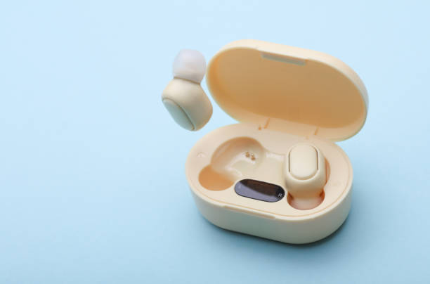 istock Wireless Earphones with Charging Case on blue Background 2192836760