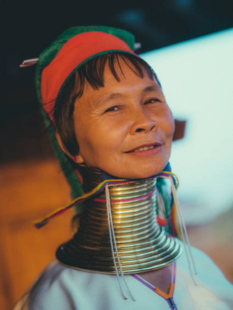 Inle Lake, Myanmar - March 2, 2010: Portrait of a woman from the Padaung tribe also known as the Giraffe tribe, wearing the traditional metal rings around her neck.