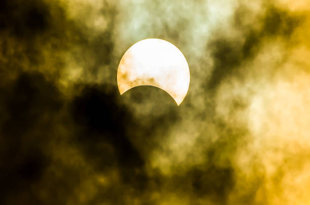 istock A sun is seen in the sky with a dark cloud in the background 2192838916