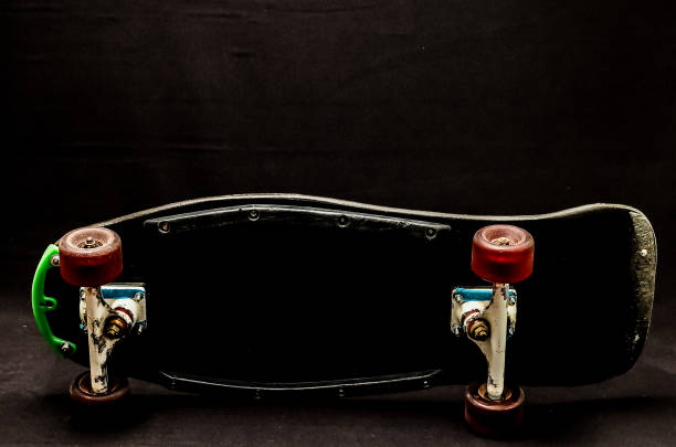 istock A skateboard with green wheels is sitting on a black surface 2192838958