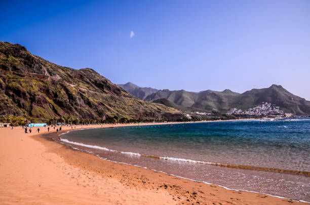 istock A beach with a blue ocean and a mountain in the background 2192838963