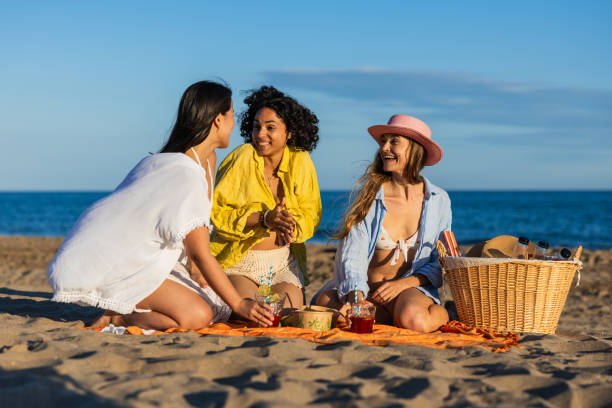 istock Multiethnic friends enjoying picnic on the beach 2192840168