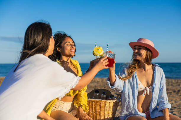 istock Multiethnic girlfriends toasting cocktails at the beach 2192840786