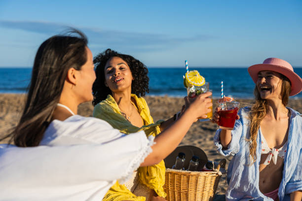 istock Multiethnic girlfriends toasting with fresh cocktails at the beach 2192840811