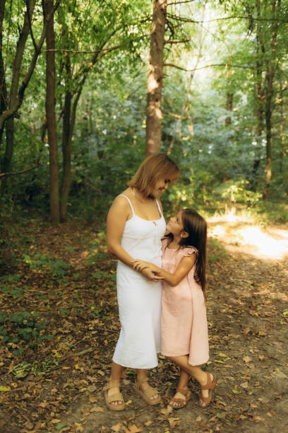 istock mother and daughter walking in nature 2192841132