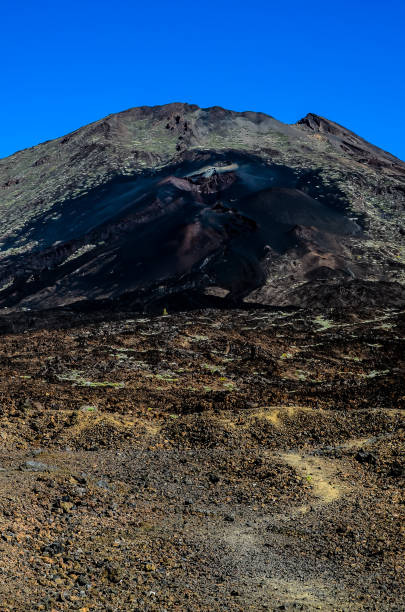 istock A mountain with a black peak and a blue sky in the background 2192842236