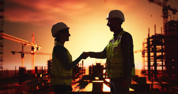 istock Silhouette Of Two Architects 2192842687