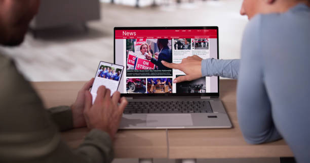 istock Watching News On Screen. Reading Newspaper Website 2192842785
