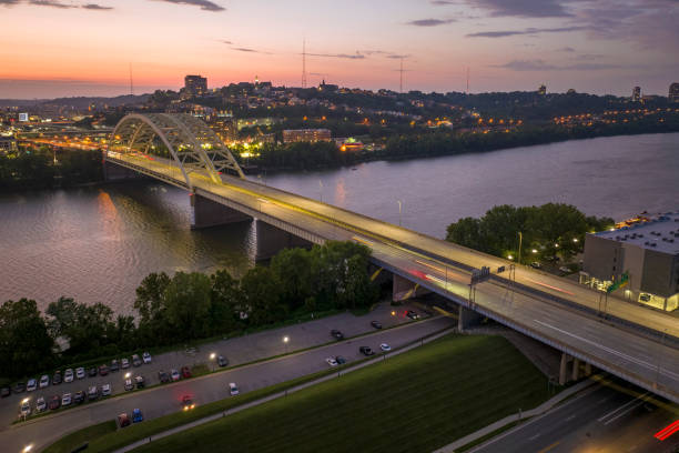 istock Highway traffic in Cincinnati, Ohio on Daniel Carter Beard Bridge with brightly illuminated high skyscraper buildings in downtown district. American city with business financial district at night 2192844539