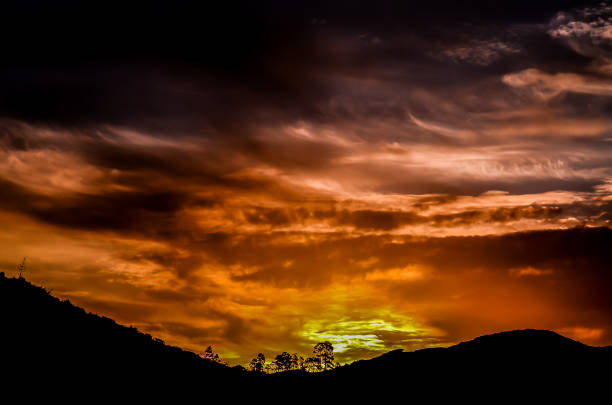 istock A beautiful sunset over a mountain range with a few trees in the foreground 2192844806