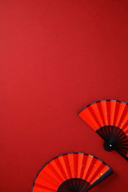 istock Japanese folding fans on red background. Flat lay, top view, vertical 2192846547