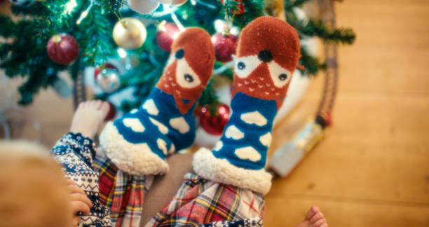 istock Caucasian Boy in Festive Pajamas Admiring Christmas Tree 2192847231