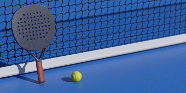 istock A padel racket and ball are positioned on a blue court next to a net. 3d rendering 2192848474