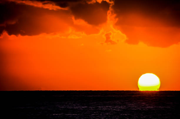 istock The sun is setting over the ocean, creating a beautiful and serene atmosphere 2192850077