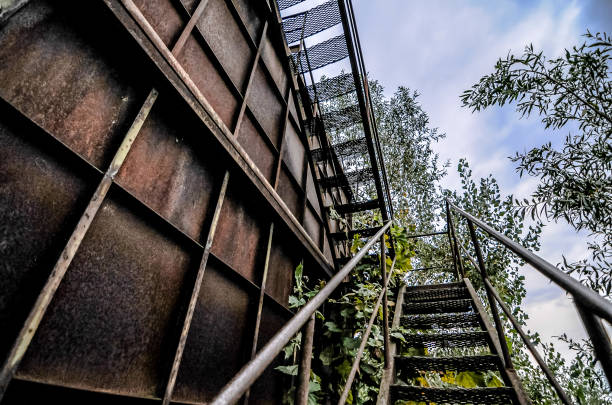 Red steel fire escape stairs in city environment