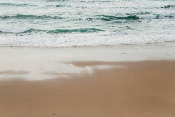 Sea waves and beach sand