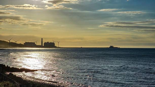 istock Sunset over coastal industrial landscape with wind turbines. 2192852799
