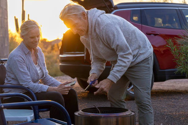 Mature couple enjoy campfire in desert