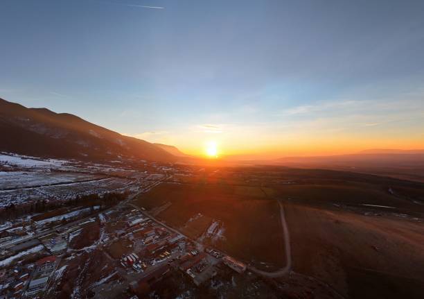 istock Aerial sunset over expansive landscape with mountains. 2192853179