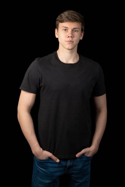 istock A young man in a black T-shirt on a black background. 2192853440