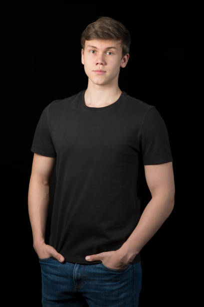 istock A young man in a black T-shirt on a black background. 2192853443