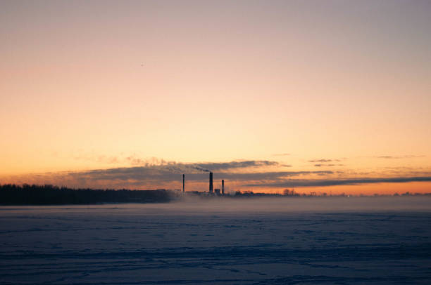 Cold winter sunset with a beautiful factory at the background