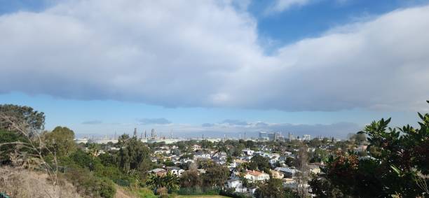 Expanse of suburbia with a refinery on the background