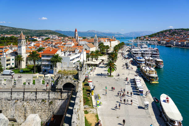 Trogir, Croatia - August 16, 2024: Beautiful old buildings, boats and yachts on the promenade in Trogir, Croatia. Sunny summer day in Trogir.