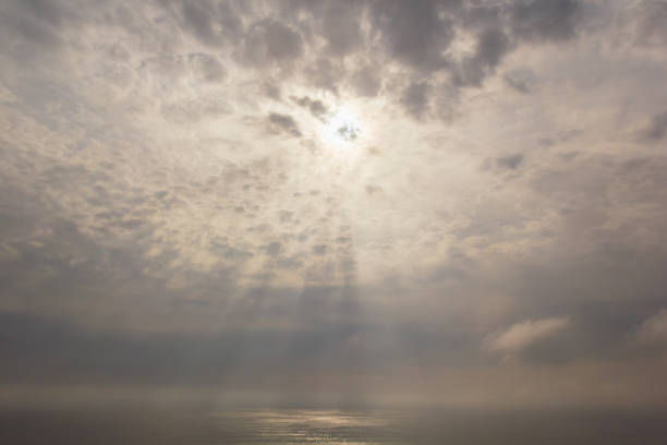 The light rays through the clouds over the sea