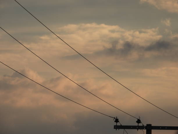 Sunset in a suburban area with a view of telephone lines