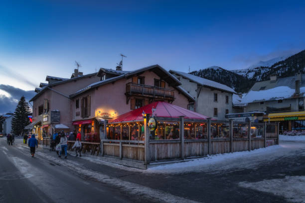 Montgenevre, France, 16 Jan 2024 A cozy winter evening at a mountain restaurant with sparkling lights, where guests enjoy the festive atmosphere and warm hospitality