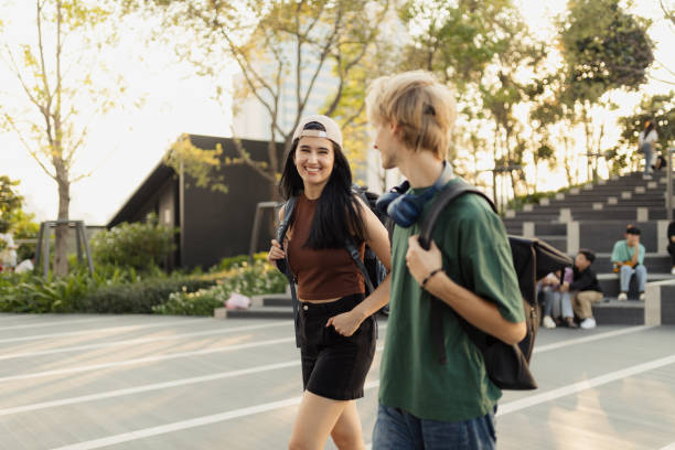 istock Two Young Friends Smiling and Walking Outdoors on a Sunny Day in a Park 2192861251