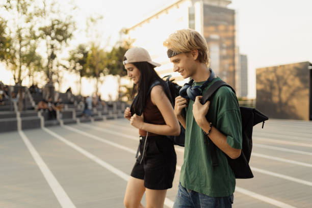 istock Two Friends Enjoying a Walk Outdoors with Backpacks at Sunset 2192861253
