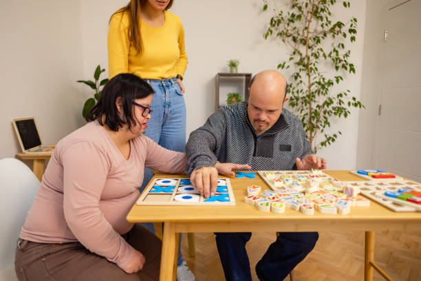 istock Man and Woman with Down Syndrome in Classroom Fun 2192864036