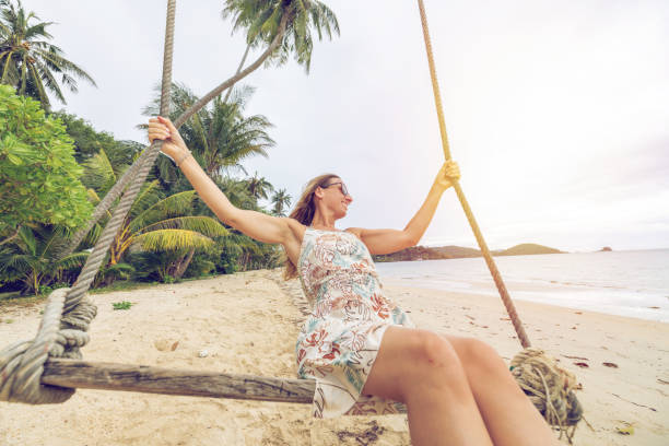 istock Woman Relaxing on a Beach Swing Under Palm Trees 2192865045