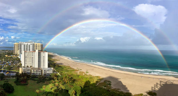 istock Beautiful double rainbow over North Palm Beach with clouds in the sky 2192865590