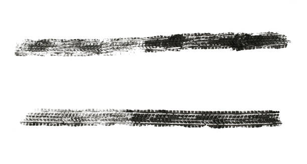black traces of tractor tires on white background.