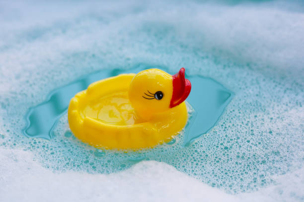 istock Yellow rubber duck on water with soap foam 2192870822